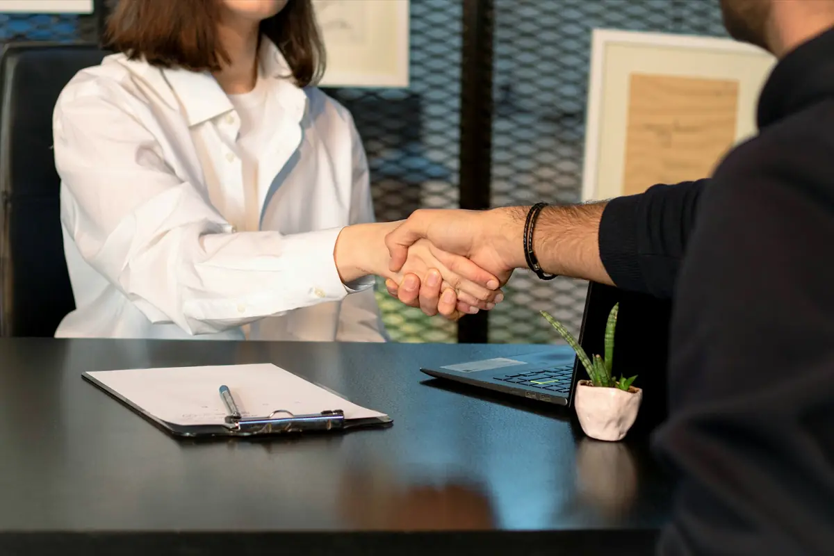Apretón de manos entre abogada y cliente tras la consulta